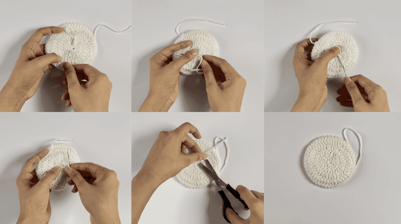 Crochet sunflower coaster fastening off: hands cutting yarn and securing the final tail to prevent unraveling after round completion