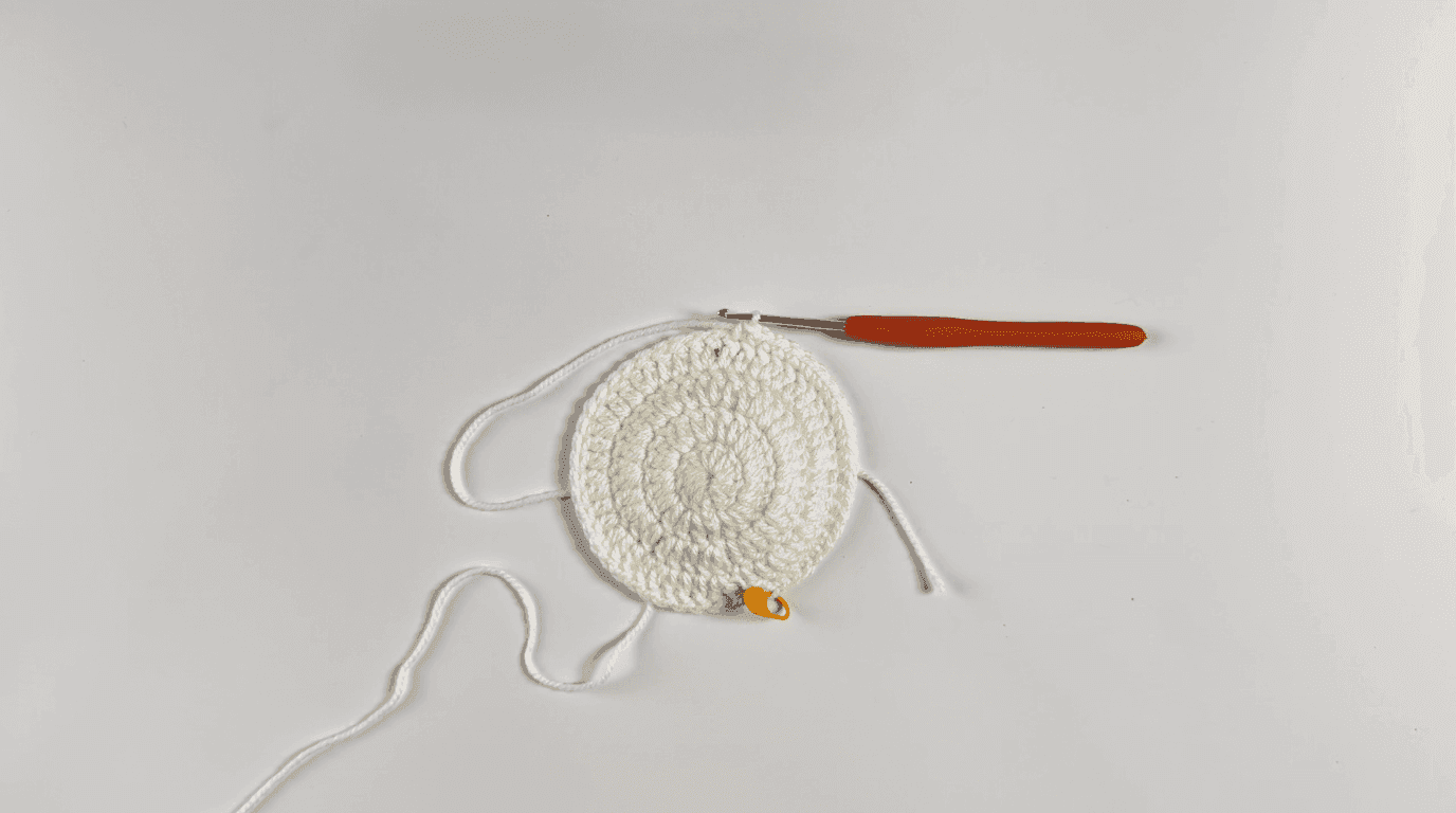 Crochet sunflower coaster Round 5: completed flat coaster base with loose single crochet round showing perfect flatness and finished dimensions