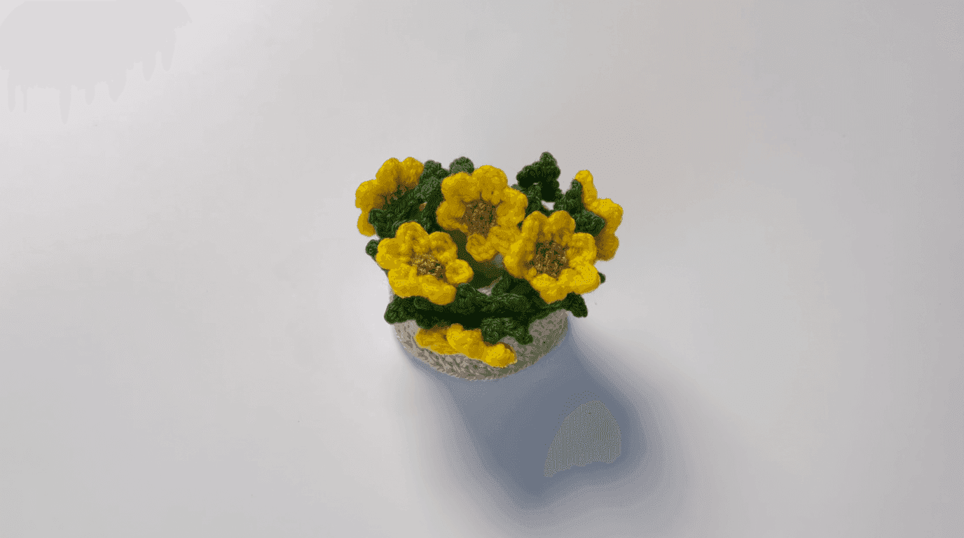 Styled crochet sunflower pot arrangement: beige pot filled with yellow mini sunflowers and green leaves creating potted flower display on neutral background